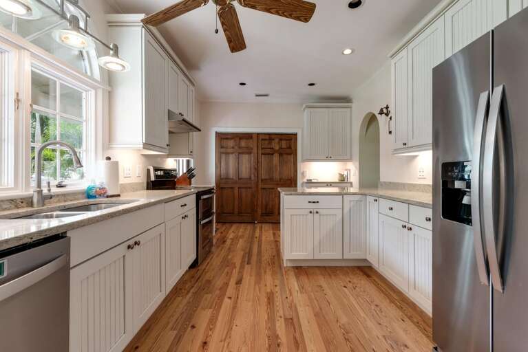 Cook for the whole crew without ever running out of counter space — this kitchen was stocked for a house this size, not a weekend getaway.