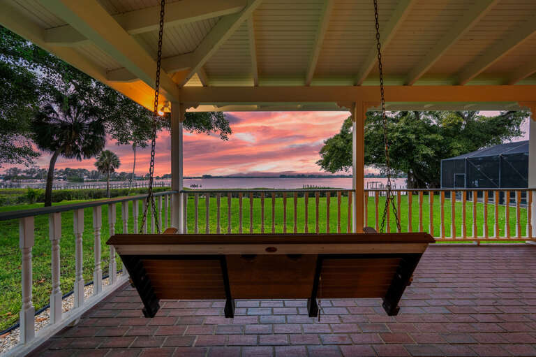 Golden hour has a permanent seat reserved right here. Grab a drink, take the swing, and watch the sky put on a show over the water.