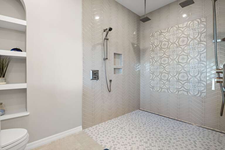 Rain shower, dual heads, and tile for days. This shower doesn't just get you clean — it gets you ready for vacation.