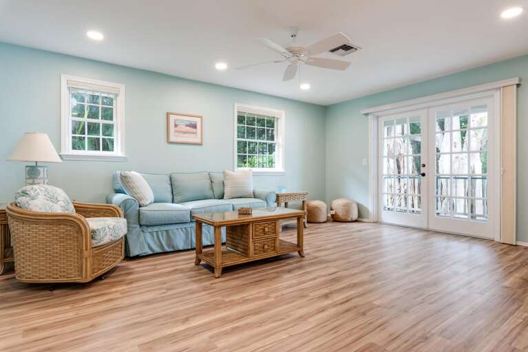 Stretch out on your own in the guest house living room, double doors open to the same water view as the main house.