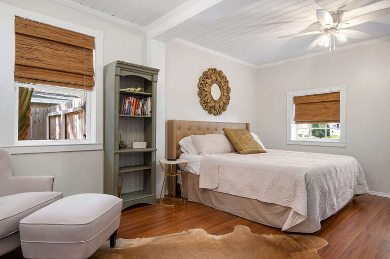 Claim the queen bed with the tufted headboard and a room with enough personality to not feel like a backup bedroom. Everyone argues over this one on the next trip.