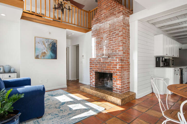 Find a brick fireplace in a Florida vacation house — not something you see every day. Light it on a cool evening, something simmering in the kitchen, and stay.