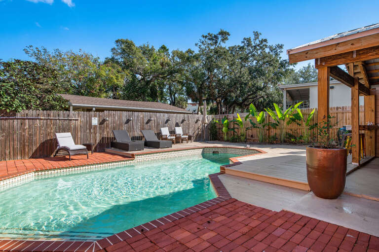 Grab a lounge chair along the fence and stay put for the afternoon. The pool edge is wide enough that nobody has to fight for a spot.