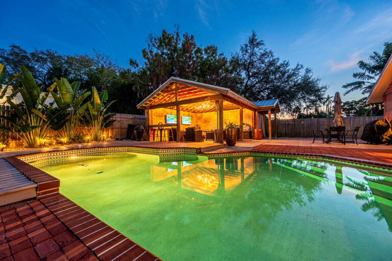 Sink into the glow — the pool heats up after sunset and the cabana lights the whole yard for exactly this moment. Your group gathered, drinks in hand, nowhere else to be.