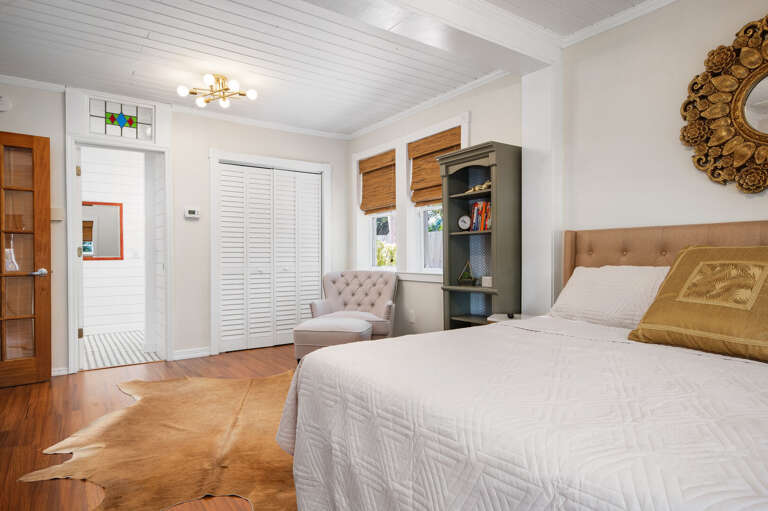 Sleep in the master suite where the stained glass transom catches morning light and the sitting area is there for anyone not ready to rush the day.