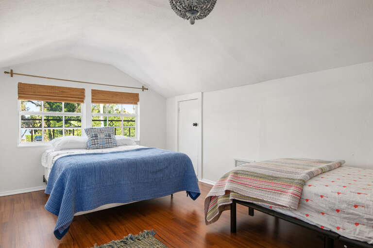 Sleep under a vaulted ceiling with a second single bed for when the kids stay close. Step outside the door and the whole loft is waiting.