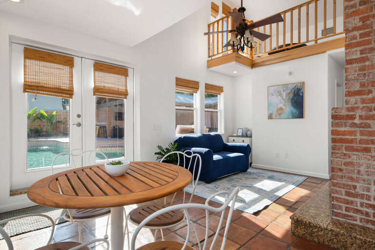 Step away from the bistro table, look up, and find the loft balcony right there. The sunroom keeps the whole house feeling connected from one floor to the next.