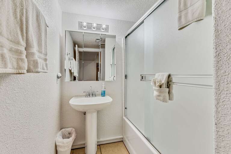 Attached to Bedroom 5 Jack-and-Jill bathroom. The first side includes a shower/bathtub combination and single vanity, while the second side offers a commode and an additional vanity. Attached to Bedroom 5 Jack-and-Jill bathroom. The first side includes a shower/bathtub combination and single vanity, while the second side offers a commode and an additional vanity.