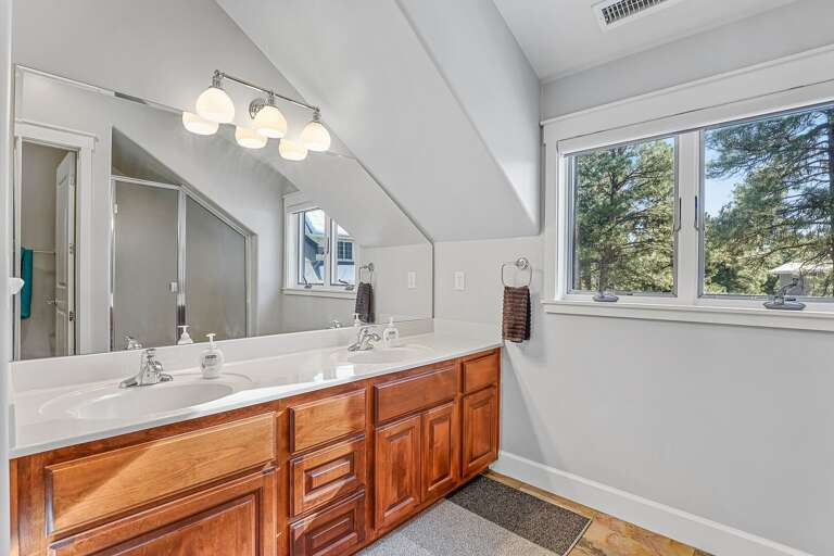 Full Bathroom - 2nd Floor: Shared by the two guest bedrooms, featuring a double vanity, private commode room, and a walk-in shower. Full Bathroom - 2nd Floor: Shared by the two guest bedrooms, featuring a double vanity, private commode room, and a walk-in shower.