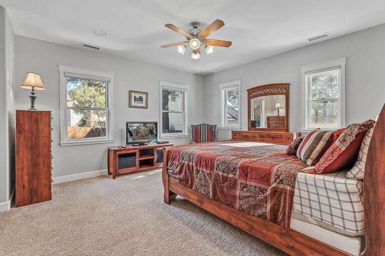 Primary Master Suite-  1st Floor: Queen bed with a memory foam topper, TV, lounge chair, loveseat, massive walk-in closet, and an en-suite bathroom Primary Master Suite-  1st Floor: Queen bed with a memory foam topper, TV, lounge chair, loveseat, massive walk-in closet, and an en-suite bathroom