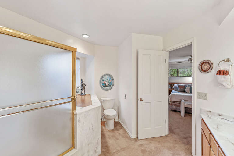 Master Bedroom - 2nd Floor: A luxurious space with a king-size bed, a crib for little ones, a TV, and an en-suite bathroom featuring a dual-sink vanity and a tub/shower combination. Master Bedroom - 2nd Floor: A luxurious space with a king-size bed, a crib for little ones, a TV, and an en-suite bathroom featuring a dual-sink vanity and a tub/shower combination.