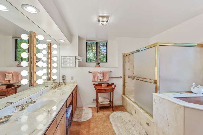 Master Bedroom - 2nd Floor: A luxurious space with a king-size bed, a crib for little ones, a TV, and an en-suite bathroom featuring a dual-sink vanity and a tub/shower combination. Master Bedroom - 2nd Floor: A luxurious space with a king-size bed, a crib for little ones, a TV, and an en-suite bathroom featuring a dual-sink vanity and a tub/shower combination.