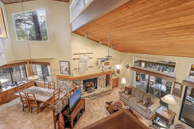 Unwind in a warm and inviting space complete with a wood-burning fireplace, a Roku-connected TV, and ample plush seating for everyone to relax. Unwind in a warm and inviting space complete with a wood-burning fireplace, a Roku-connected TV, and ample plush seating for everyone to relax.