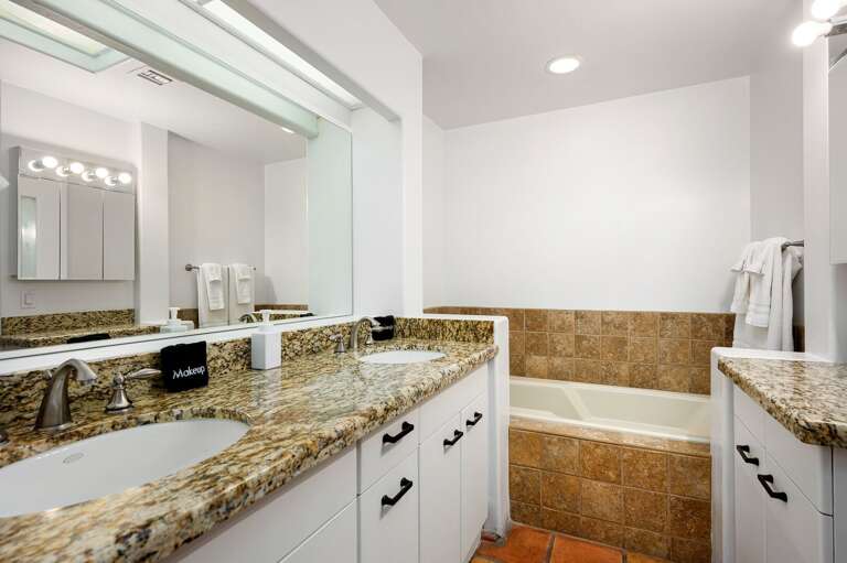 Double sinks a tub to the right.