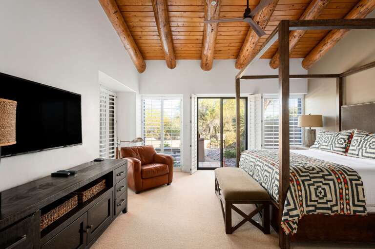 Master bedroom with seating and access to the patio space.