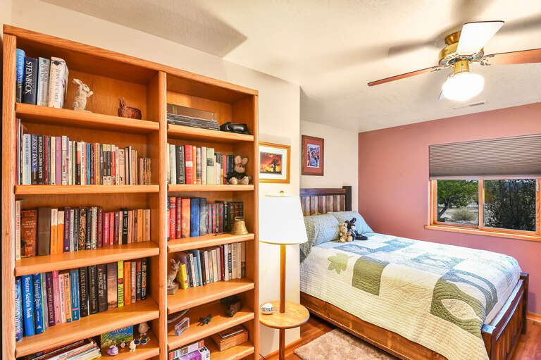 Cozy bedroom with a thoughtful collection of books, creating the perfect atmosphere for relaxation and reading. Cozy bedroom with a thoughtful collection of books, creating the perfect atmosphere for relaxation and reading.