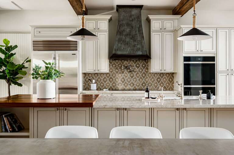 The kitchen has double ovens, a large island prep station, and water pot filler.