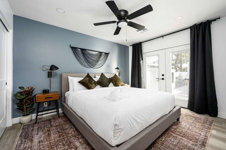 Second bedroom with an en-suite bathroom and access to the backyard.