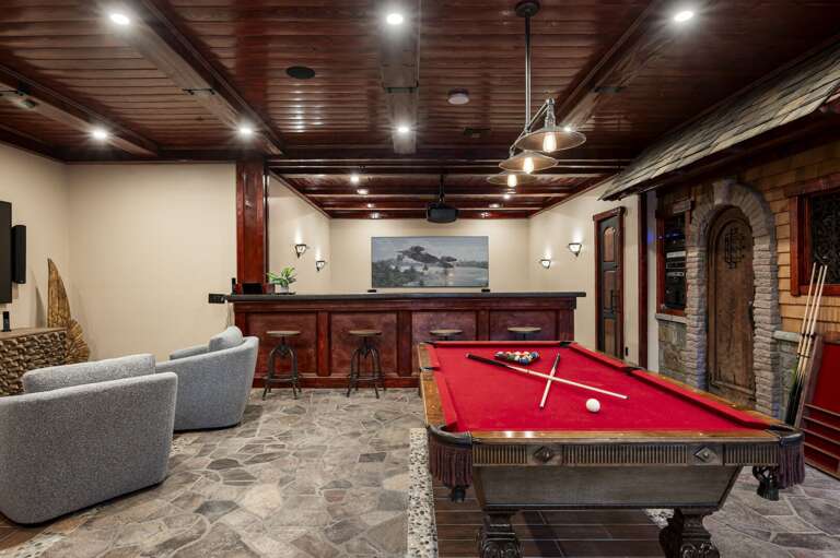 Enjoy endless entertainment in the spacious game room, featuring a pool table, private bar, and comfortable lounge seating. Unwind in the dedicated theater room, perfect for a relaxing evening.