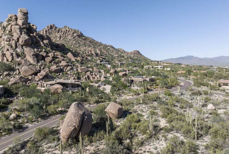 Discover a luxurious desert retreat nestled among dramatic rock formations, offering breathtaking mountain views and stunning natural surroundings.