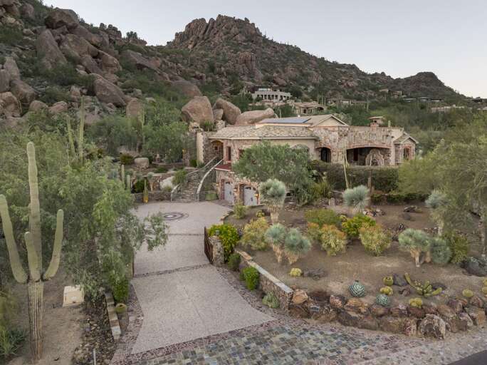 Discover a luxurious desert retreat nestled among dramatic rock formations, offering breathtaking mountain views and stunning natural surroundings.