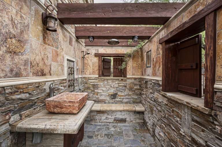 Refresh in the luxurious open-air shower, featuring natural stone finishes and rustic desert charm.