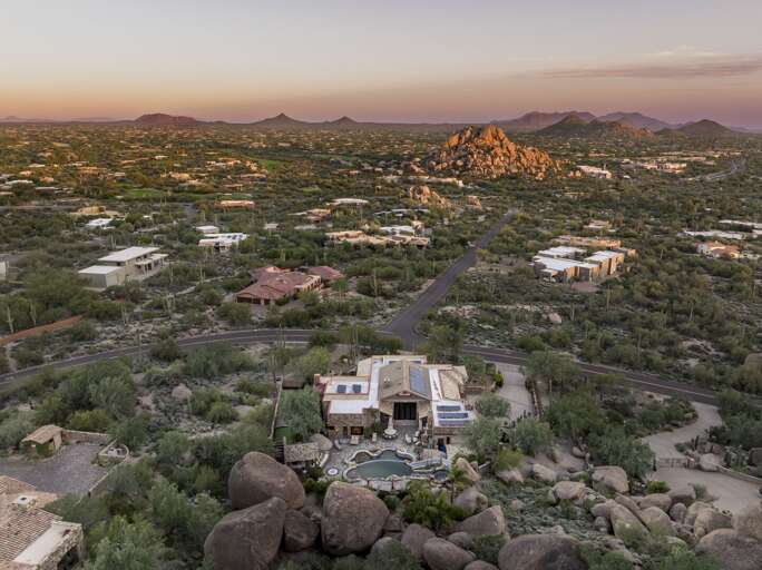 Discover a luxurious desert retreat nestled among dramatic rock formations, offering breathtaking mountain views and stunning natural surroundings.