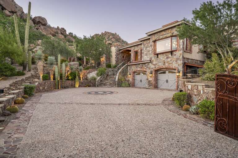 Arrive in style with a grand stone exterior, beautifully landscaped grounds, and stunning mountain views.