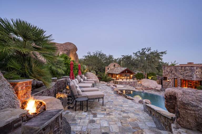 As the sun sets, this extraordinary desert retreat comes to life with glowing pool lights, inviting