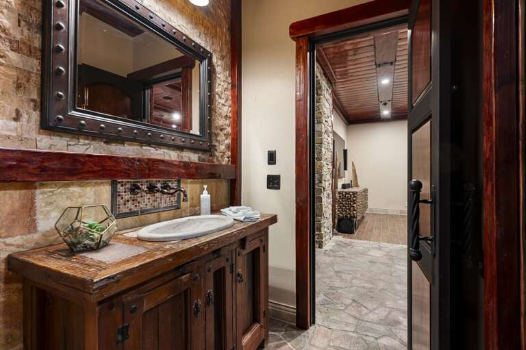 Relax in this inviting bedroom featuring rich wood accents, plush bedding, and private patio access.