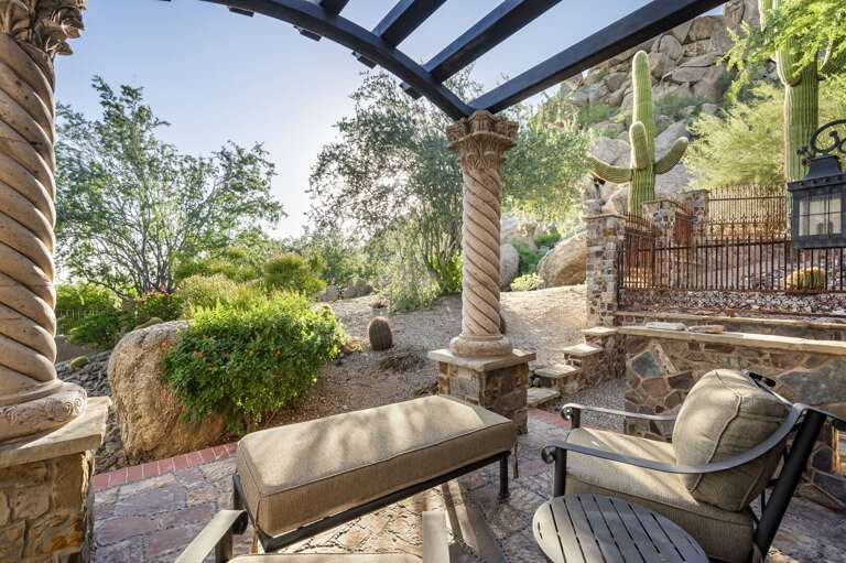 Retreat to this luxurious bedroom featuring a cozy fireplace, elegant wood finishes, and a private p
