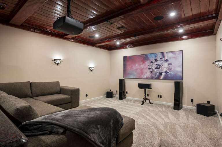 Enjoy endless entertainment in the spacious game room, featuring a pool table, private bar, and comfortable lounge seating. Unwind in the dedicated theater room, perfect for a relaxing evening.