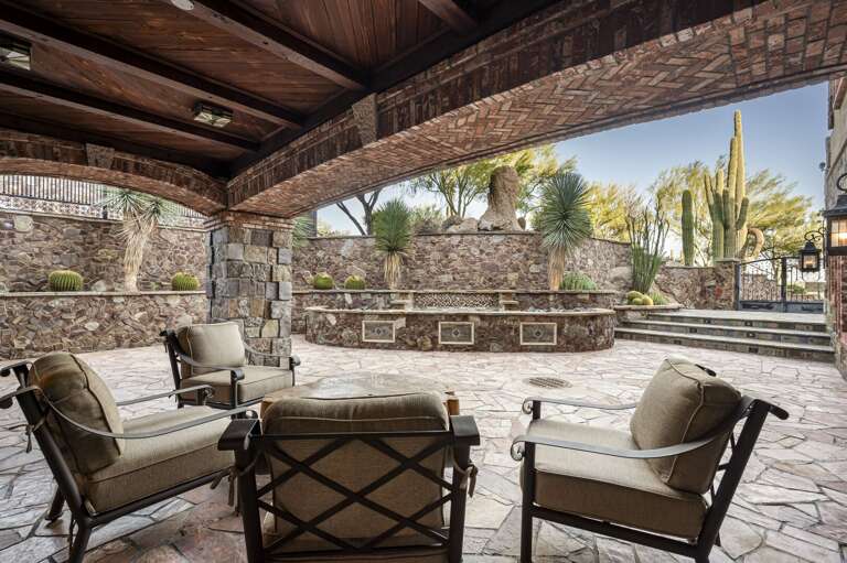 Relax in the inviting outdoor courtyards, featuring elegant stonework, comfortable seating, and stunning desert surroundings.