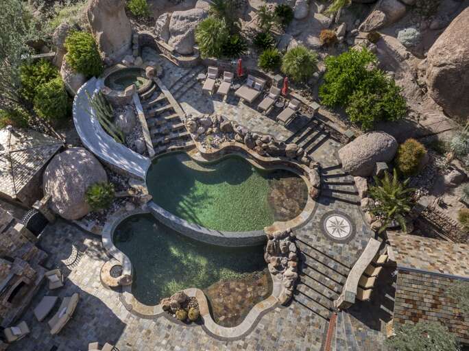 Discover a luxurious desert retreat nestled among dramatic rock formations, offering breathtaking mountain views and stunning natural surroundings.