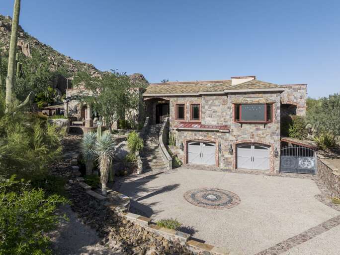 Discover a luxurious desert retreat nestled among dramatic rock formations, offering breathtaking mountain views and stunning natural surroundings.