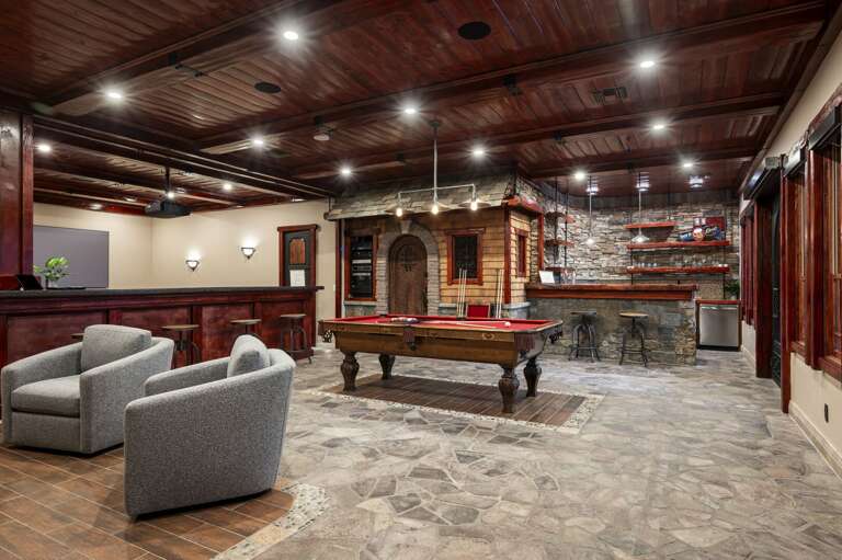 Enjoy endless entertainment in the spacious game room, featuring a pool table, private bar, and comfortable lounge seating. Unwind in the dedicated theater room, perfect for a relaxing evening.