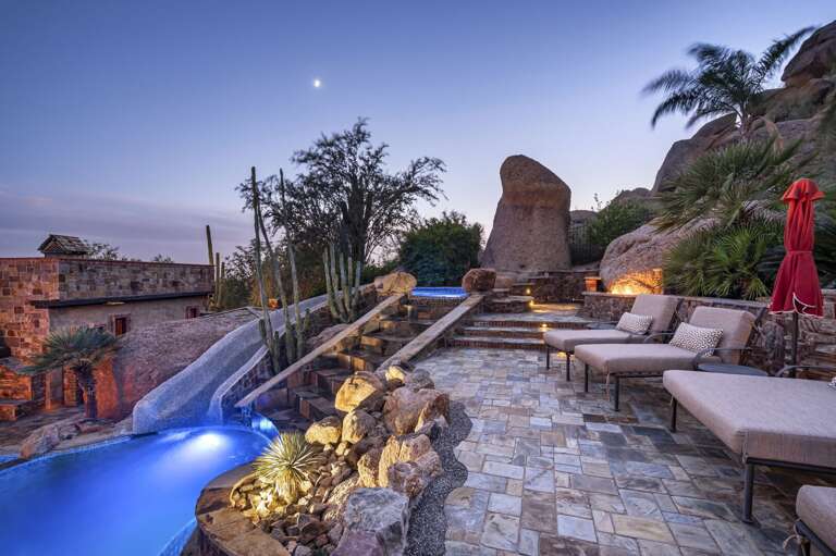 As the sun sets, this extraordinary desert retreat comes to life with glowing pool lights, inviting