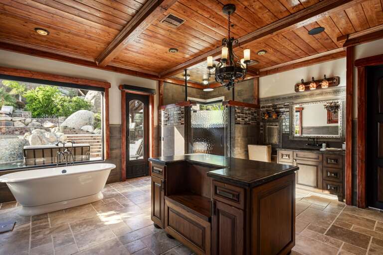 Indulge in the luxurious primary bathroom, featuring a spacious walk-in shower, dual vanities, and a