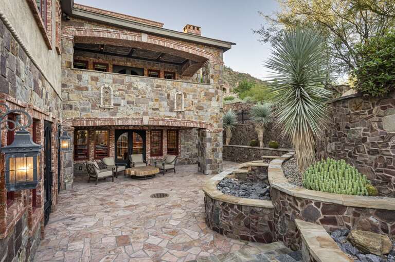 Relax in the inviting outdoor courtyards, featuring elegant stonework, comfortable seating, and stunning desert surroundings.
