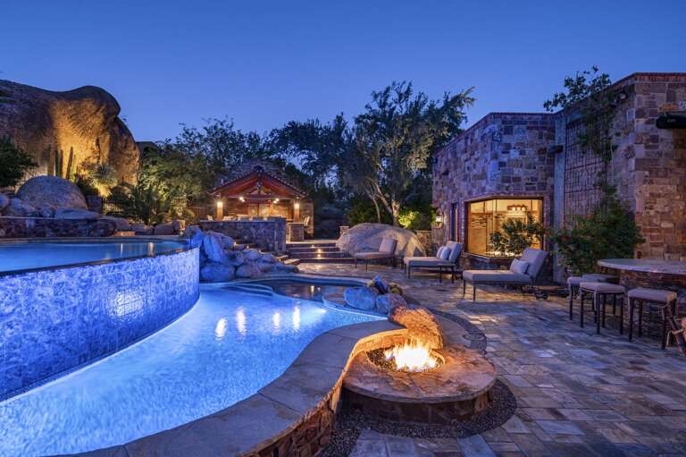 As the sun sets, this extraordinary desert retreat comes to life with glowing pool lights, inviting