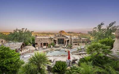 Experience luxury desert living with a resort-style pool, expansive outdoor spaces, and breathtaking mountain views.