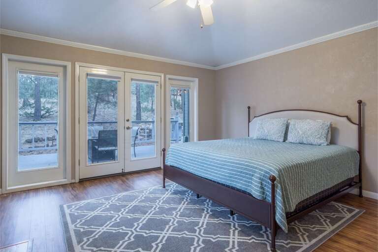 French doors open to a private deck, offering serene views and a tranquil escape.