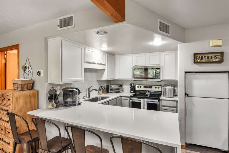 Bright open space with a fully equipped kitchen, perfect for cooking, dining, and entertaining.