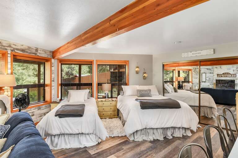 Cozy bedroom with a queen bed and twin single bed, ideal for families or small groups.