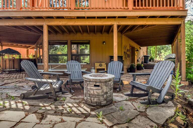 "Inviting outdoor seating around a firepit, perfect for cozy conversations and starlit evenings.