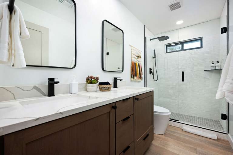 Second bathroom with walk in shower and double vanity sinks. Second bathroom with walk in shower and double vanity sinks.