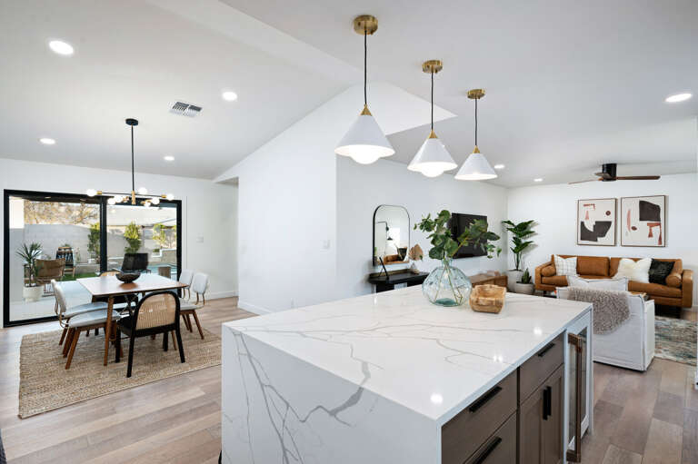 An open look from the kitchen to living room and dining. An open look from the kitchen to living room and dining.