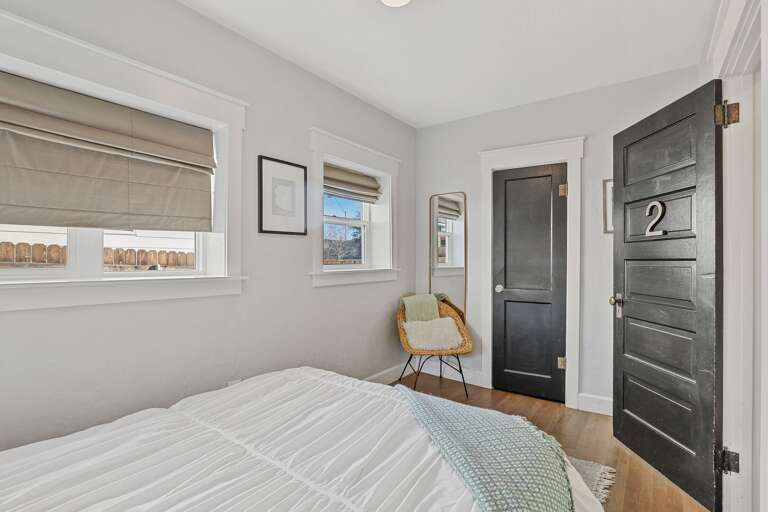 Bedroom 2: Full-size bed featuring original vintage wooden doors and hardware. Bedroom 2: Full-size bed featuring original vintage wooden doors and hardware.