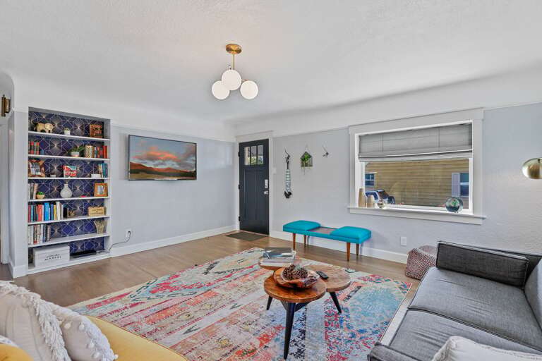 Chic Living Space: A perfect blend of modern comfort and mid-century decor, featuring beautifully restored wooden floors and doors. Chic Living Space: A perfect blend of modern comfort and mid-century decor, featuring beautifully restored wooden floors and doors.