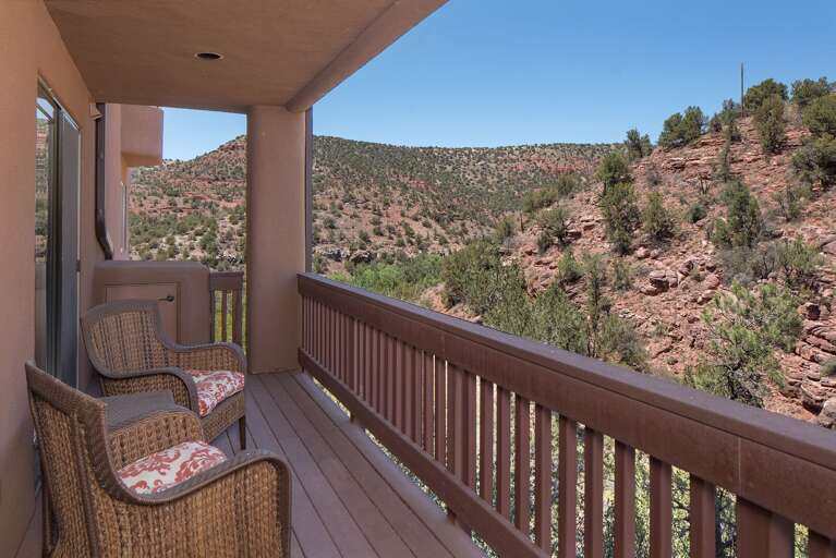 Bedroom 3: King-sized bed, flat-screen TV, and private balcony access (includes a twin cot for extra sleeping options). Bedroom 3: King-sized bed, flat-screen TV, and private balcony access (includes a twin cot for extra sleeping options).